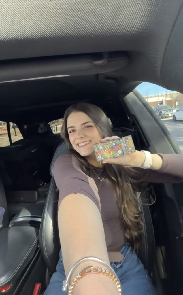 Social Media Creator Alexzandra Stroud takes a selfie in her car with a Garland Public Library card