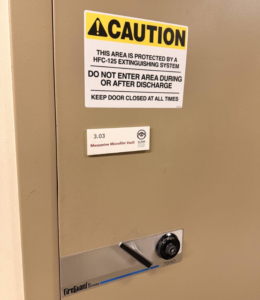 The door to the secure vault at the Shoal Creek Record Center with signage about the fire safety system